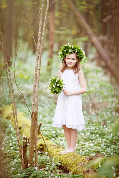 Beautiful  little girl in a white dress walks in the spring wood — Stock Photo, Image