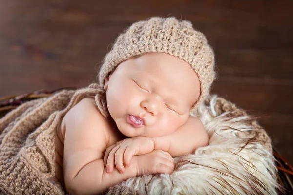 Beautiful little newborn boy 20 days sleeps in a basket whith k — Stock Image Beautiful little newborn boy 20 days sleeps in a basket whith k Stock Photo