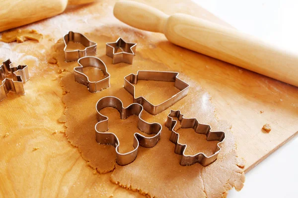 Christmas gingerbread tree cookie cutter on dough with rolling p