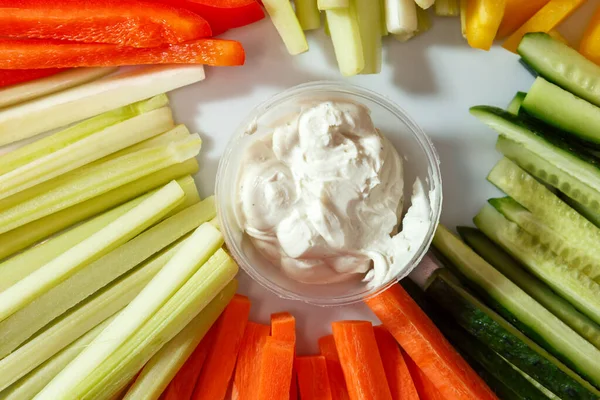 Sliced cucumbers, carrots, celery, peppers on a plate