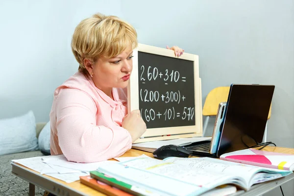 A school teacher teaches a lesson online. Distance learning during quarantine