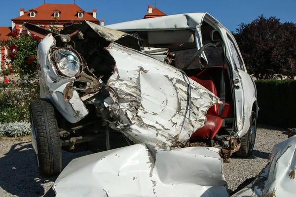 The detail of an old veteran small car after the collision with a modern car during the traffic accident. The car is destroyed completely. Shows the low level of passive safety.