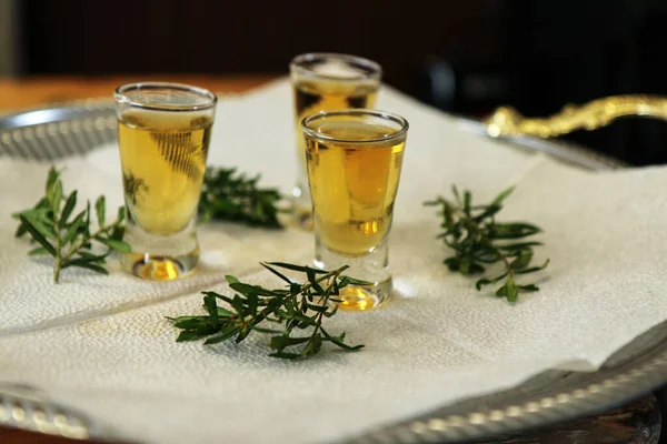 The detail of a wedding welcome drink, the shots with alcoholic drink. A tradition for the wedding guests.