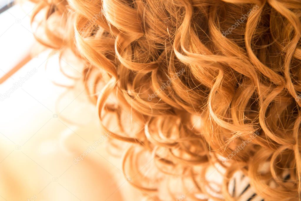The detail of the curly hair of the woman. She is a bride and is prepared for the ceremonial.