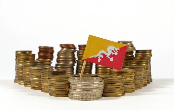 Bandeira do Butão acenando com pilha de moedas de dinheiro — Fotografia de Stock