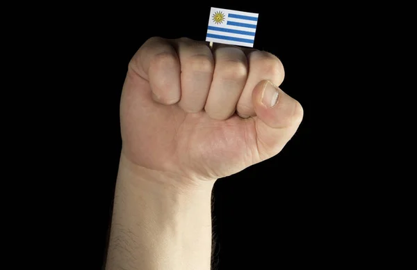 Puño de mano hombre con bandera uruguaya aislada sobre fondo negro —  Fotos de Stock