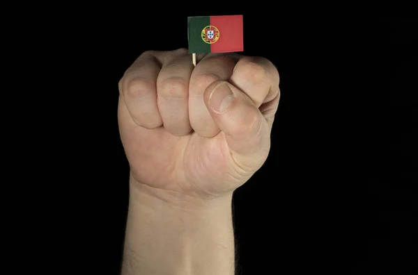 Poing main homme avec drapeau portugais isolé sur fond noir — Photo
