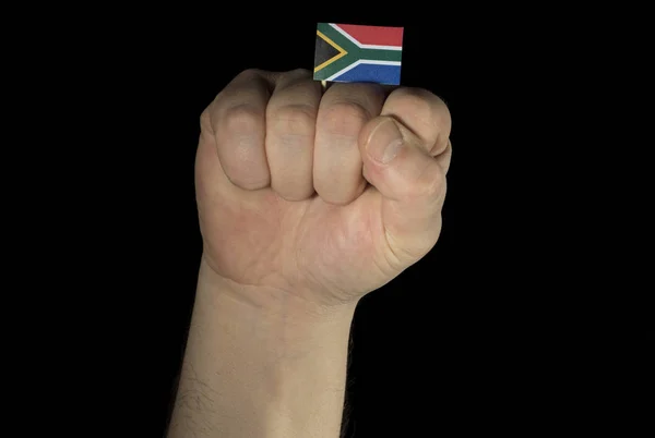 Puño de mano de hombre con bandera sudafricana aislada sobre fondo negro —  Fotos de Stock