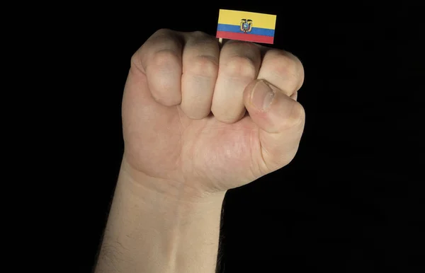 Man hand fist with Ecuadorean flag isolated on black background — Stock Photo, Image