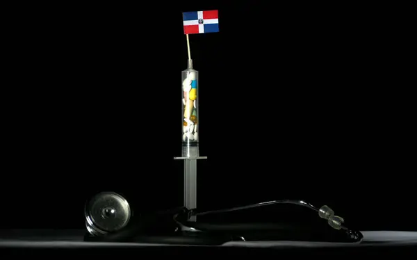 Estetoscopio y jeringa llenos de drogas inyectables bandera de República Dominicana sobre fondo negro —  Fotos de Stock