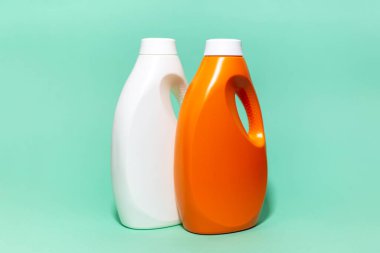 İki tane yakın plan, beyaz ve turuncu renkli, arka planda deterjan şişeleri var..