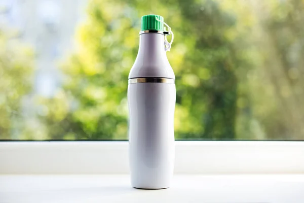 Close-up of white steel thermo bottle for water.
