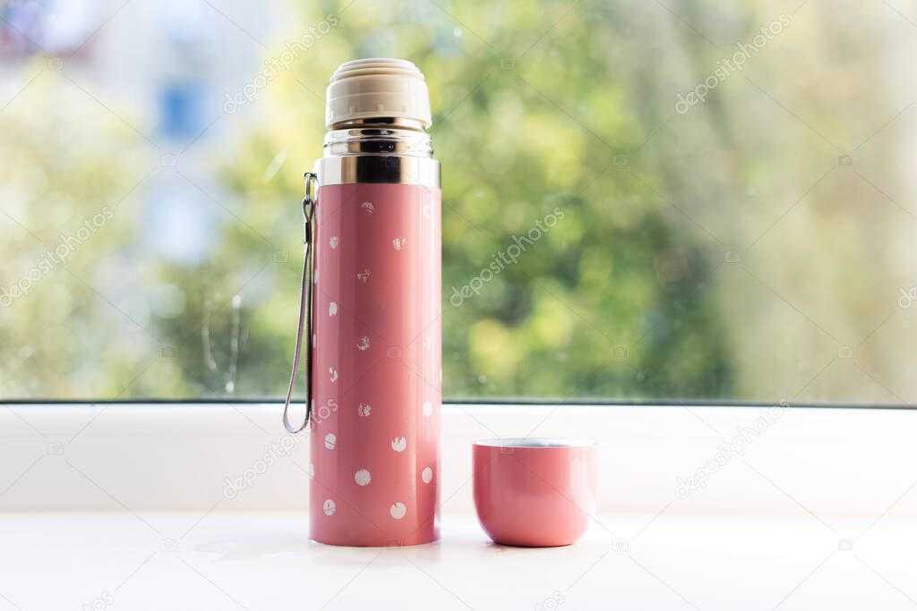 Close-up of pink thermos for kids.