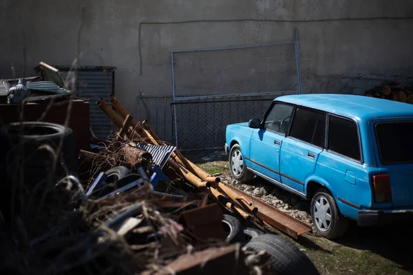 Portrait of old abandoned blue car.