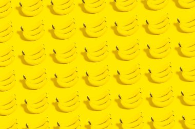 Sarı arka planda birçok muzun deseni.