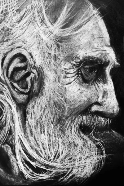 Drawing portrait of old man with charcoal and chalk on black paper.