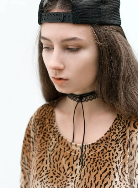 The girl in a cap and a leopard dress posing on the street — Stock Photo, Image