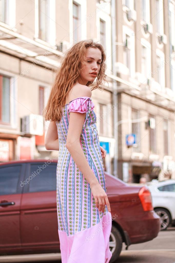 Beautiful and tall girl model appearance in stylish clothes walking around the city