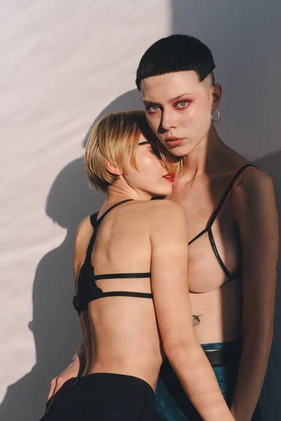 Две чувственные девушки в кружевных бюстгальтерах обнимаются — стоковое фото