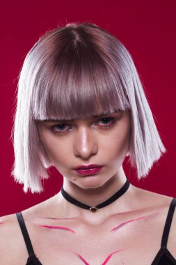 Sarı saçları ve makyaj kırmızı arka plan ile güzel kız