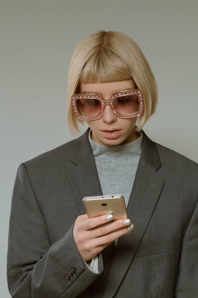 Blonde girl with short hair style in fashion glasses