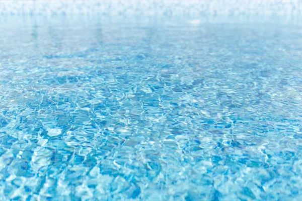 Surface of water. Texture of water. Blue water in the pool