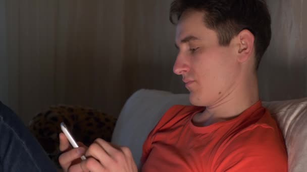 Young Man Using Smartphone Sits Sofa — Stock Video