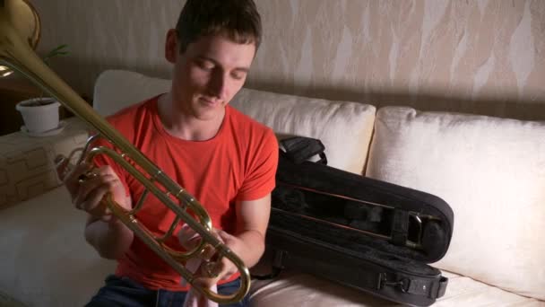 Young Musician Cleans Polishes Trombone Room Slow Motion — Stock Video