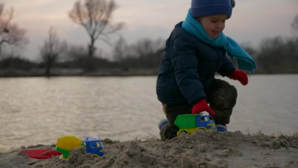 Cute Child Playing Alone Toy Trucks Vehicles Sand Beach River — Αρχείο Βίντεο