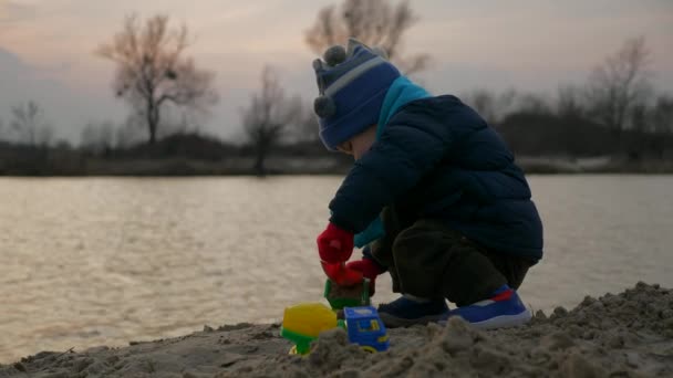 Cute Child Playing Alone Toy Trucks Vehicles Sand Beach River — Stock video