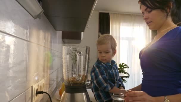 Madre Figlio Preparazione Cocktail Frutta Con Grano Germogliato Frullatore Bambino — Video Stock