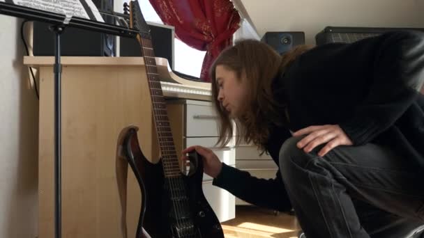 Man Wipes Dust Guitar Young Adult Musician Rocker Cares Instrument — Vídeo de stock