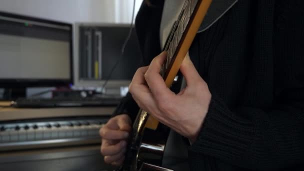 フリーボードの弦の上の指 エレクトリック ギターで演奏するクローズアップ ハンズ ホーム スタジオでは 若い成人音楽家が演奏と録音を行う 2倍スローモーション0 5速度4K 60P — ストック動画