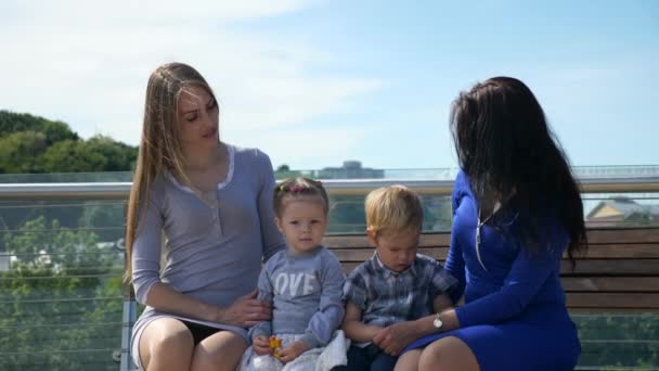 Happy Friends Mothers Sit Children Bench Pedestrian Bridge City Park — Stock video