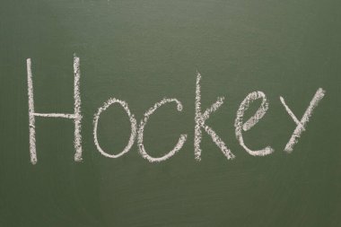 Yeşil bir tahtada el yazısıyla yazılmış tebeşir hokeyi.
