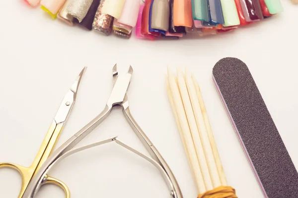 Manicure tools on a white background. Scissors, nail file, sticks, etc.