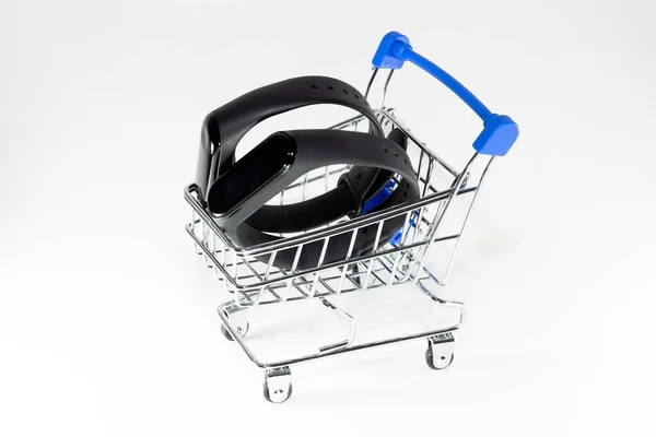 Two Fitness Bracelets Shopping Trolley White Background — Stock Photo, Image