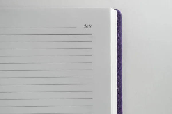 Violet diary. In the corner is the inscription Date. On white background.