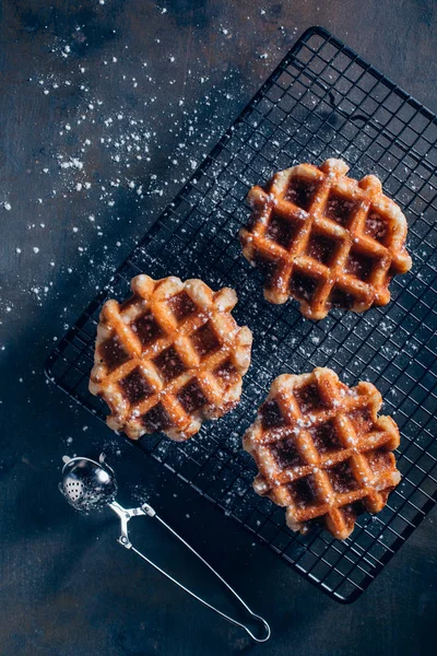 Waffles in grid with icing sugar — Stock Photo, Image