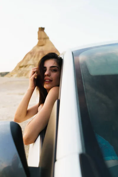 Woman hanging out of car — Stock Photo, Image