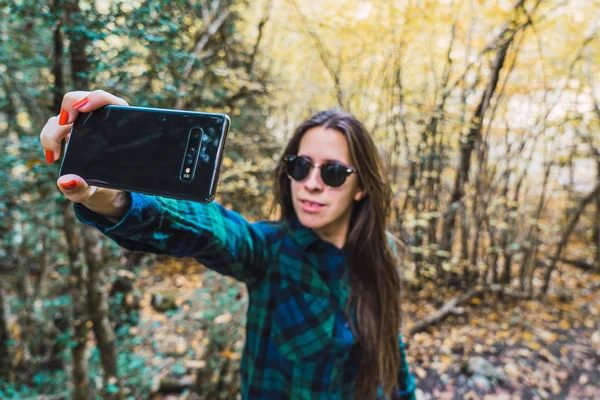 Mulher Camisa Xadrez Tirando Selfie Celular Enquanto Está Floresta Madeira — Fotografia de Stock