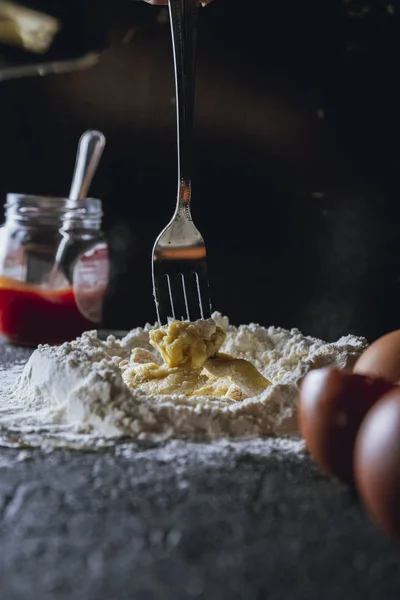 Fork Mixing Egg Flour While Preparing Dough Pasta Black Table — Stock Photo, Image