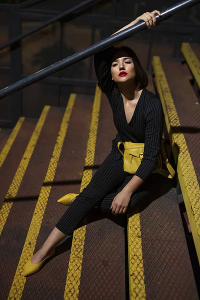 Fashionable Woman Black Dress Red Lipstick Yellow Small Bag Sitting — 图库照片