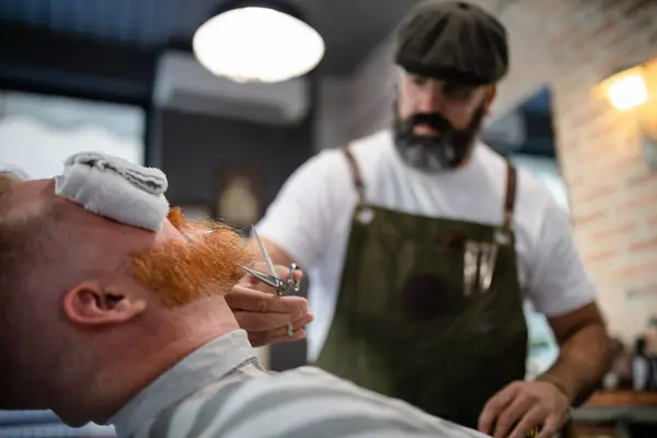 Blurred Unrecognizable Barber Scissor Fixing Redhead Man Beard Towel Covering — Stock Photo, Image