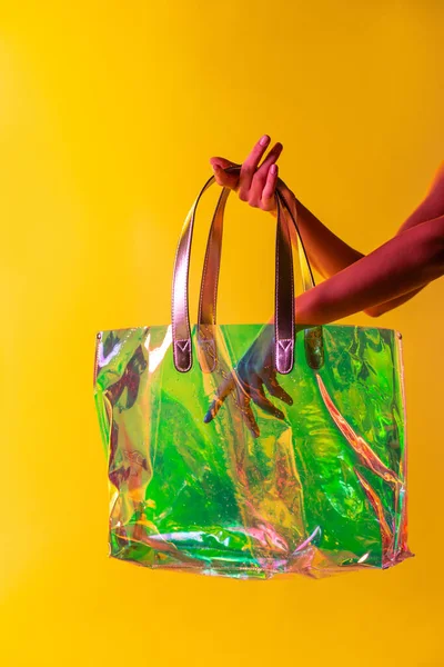 Anonymous Female Colorful Transparent Plastic Bag Yellow Background Studio — Stock Photo, Image
