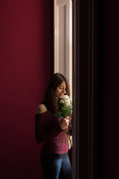 Beautiful female holding roses — Stock Photo