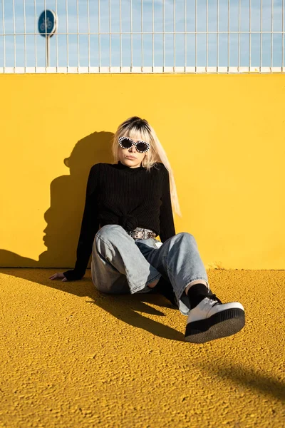 Calm young woman enjoying sunlight on stadium — Stock Photo