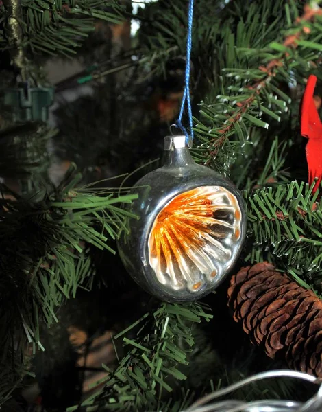 Orange round lantern. vintage christmas toys on new year tree background.