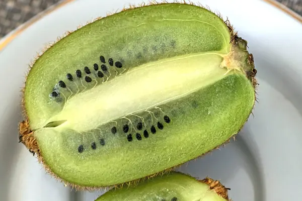 kiwi fruit cut in half on a plate