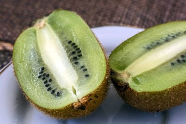 kiwi fruit cut in half on a plate